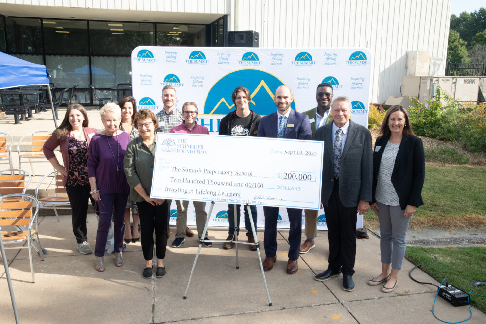 The Summit Preparatory School receives a $200,000 check from The Schneider Foundation.